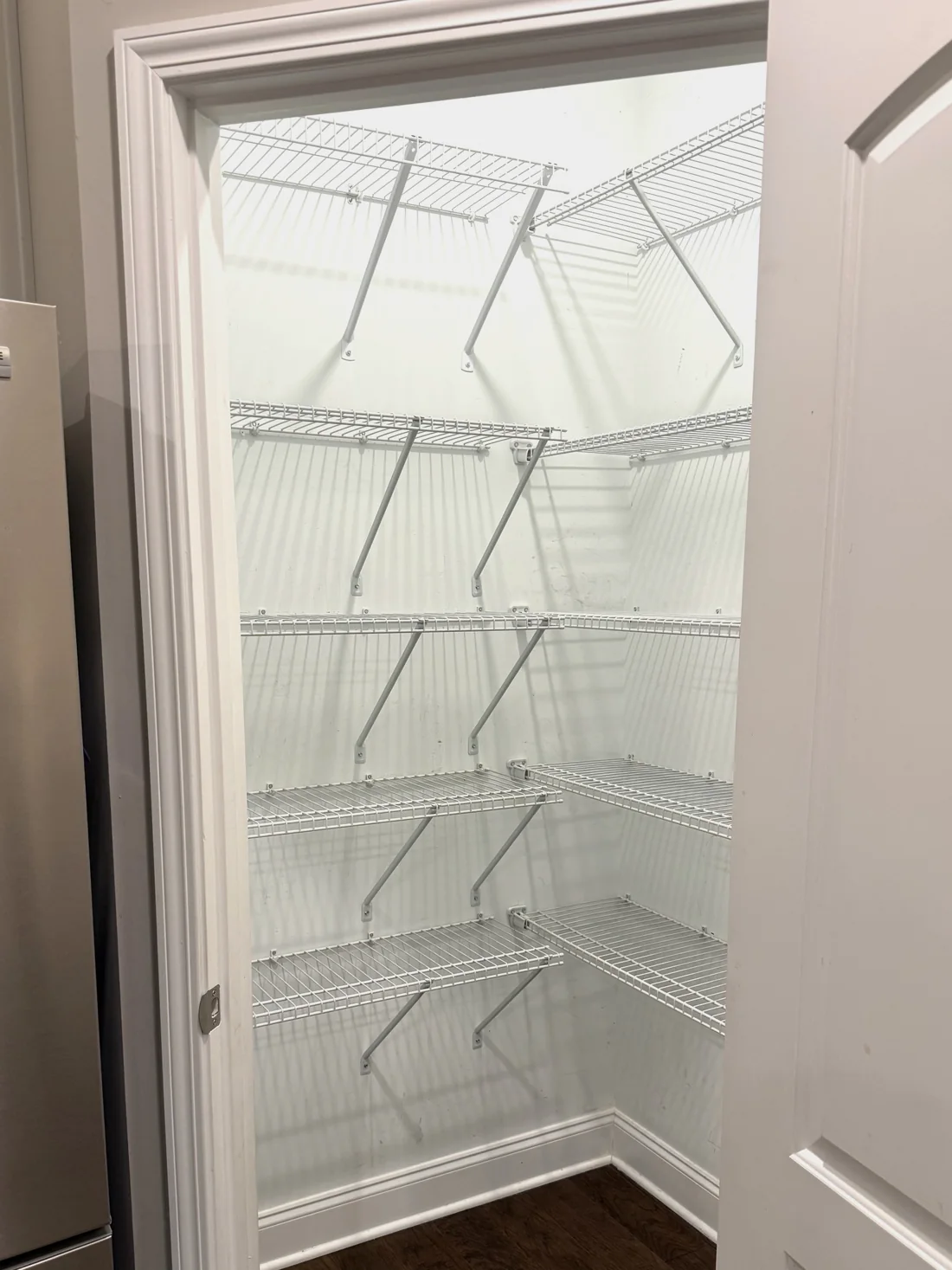 Before: builder-grade white wire pantry shelving